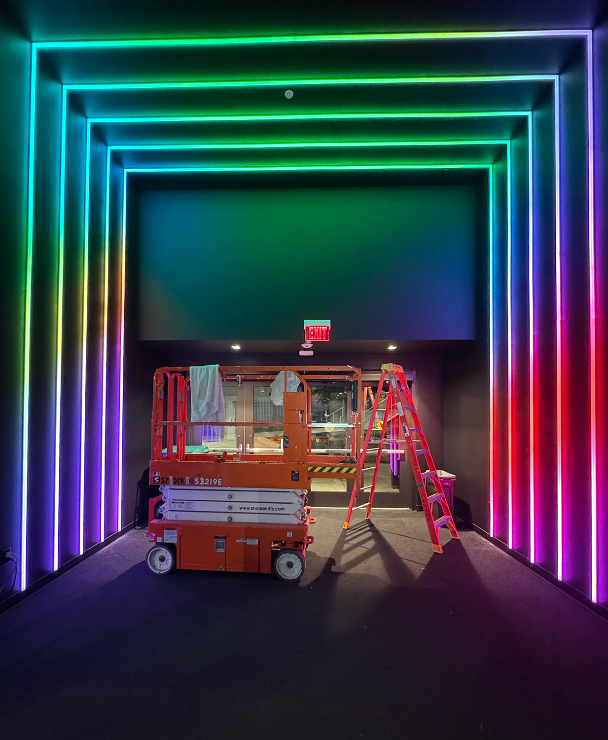 Installation view of custom lighting around a premium entrance at Moody Center.