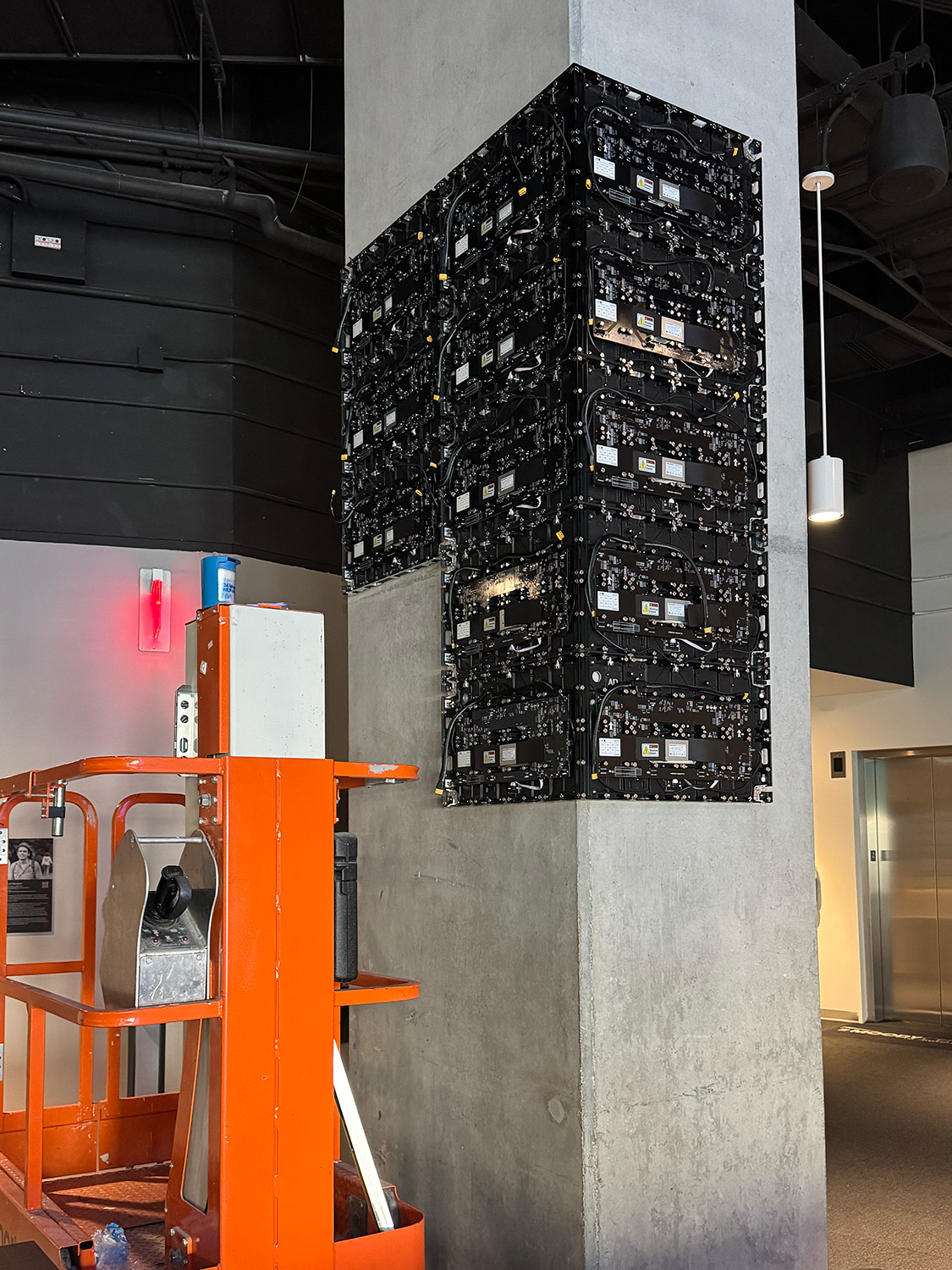 Angled view of an LED display wrapping around a column in Moody Center.